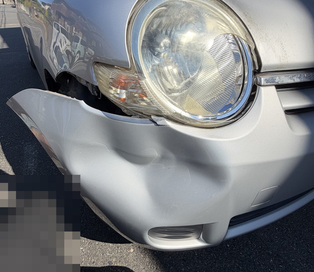 鹿と衝突してバンパーが大きく変形し外側にめくれた車の前部