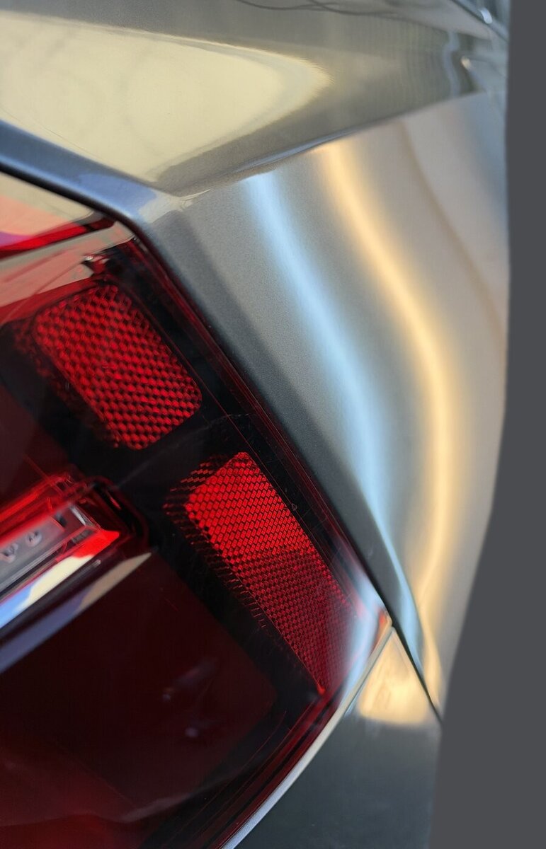 デントリペア施工後のボルボ V60 の後ろのクォーターパネル。テールランプ横の光の帯が通っている